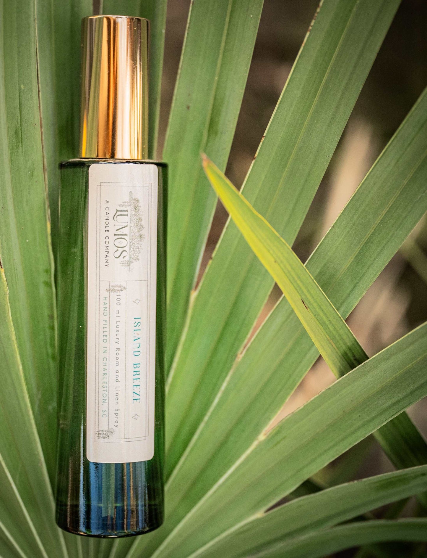 LUMOS Room + Linen Spray luxury home fragrance mist in elegant glass bottle with gold sprayer