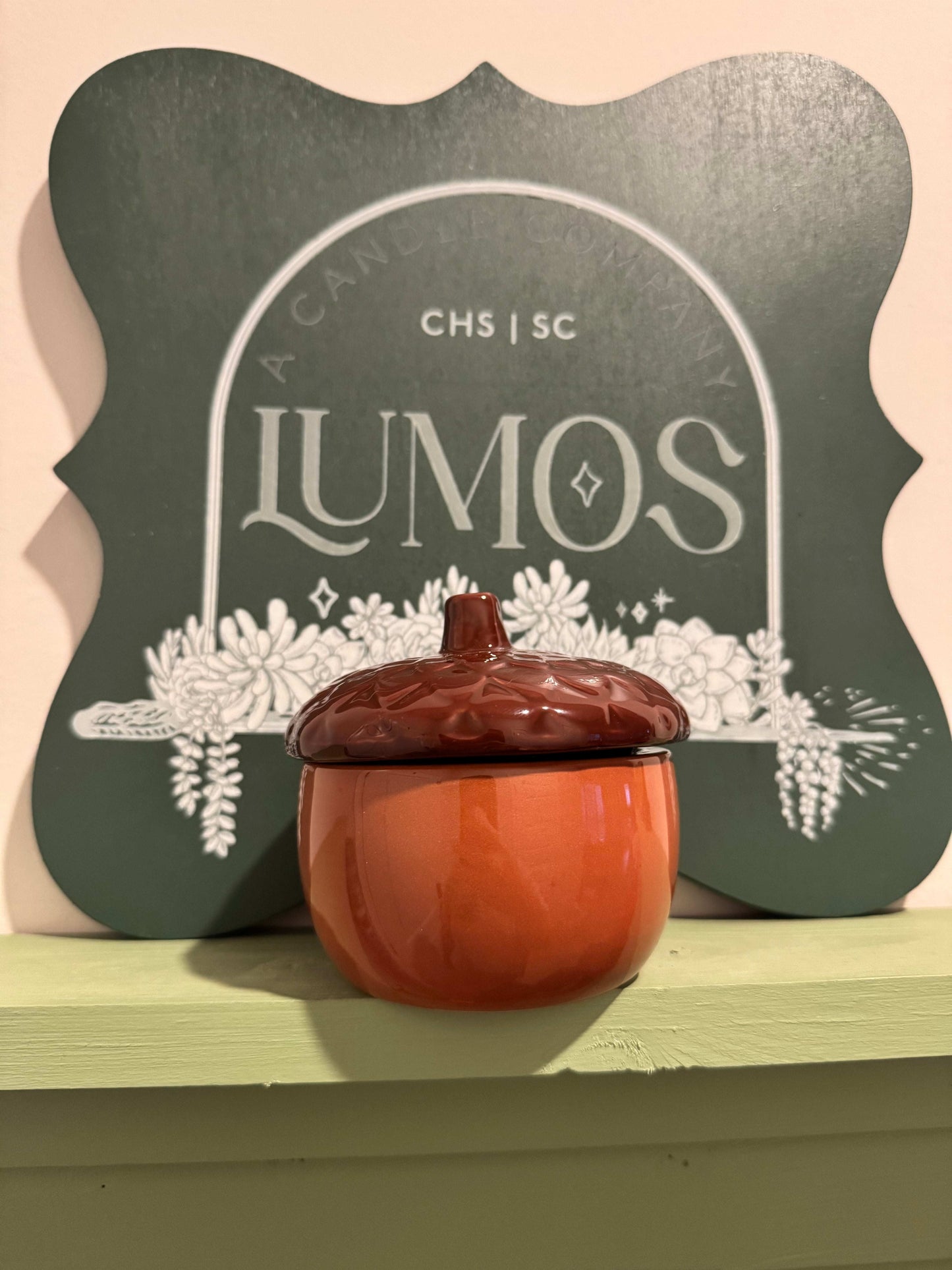 7oz fall scented candle in brown acorn ceramic vessel with limited edition Lumos autumn scents
