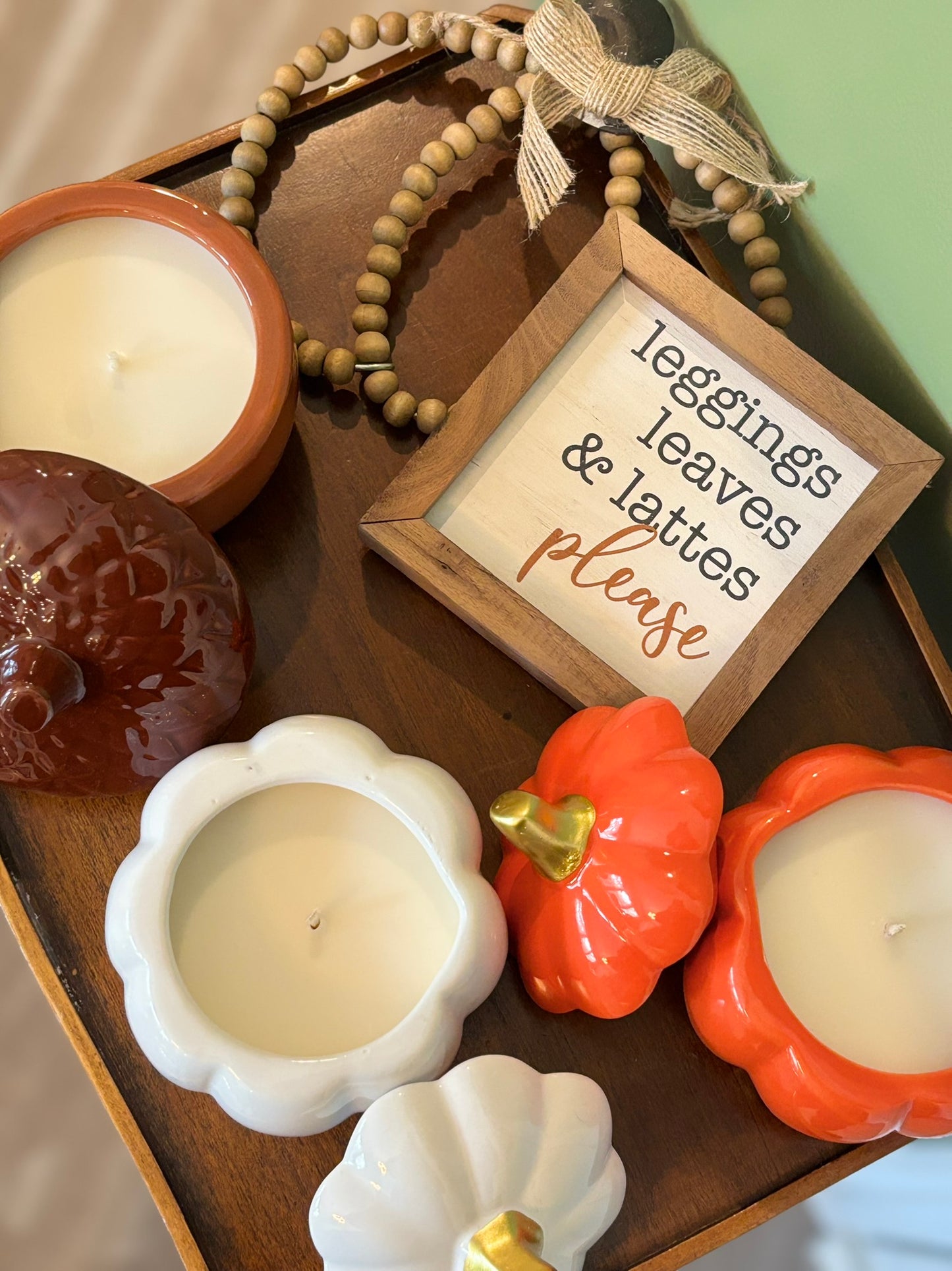Brown acorn, white pumpkin, and orange pumpkin ceramic vessels with LUMOS fall scented soy candles