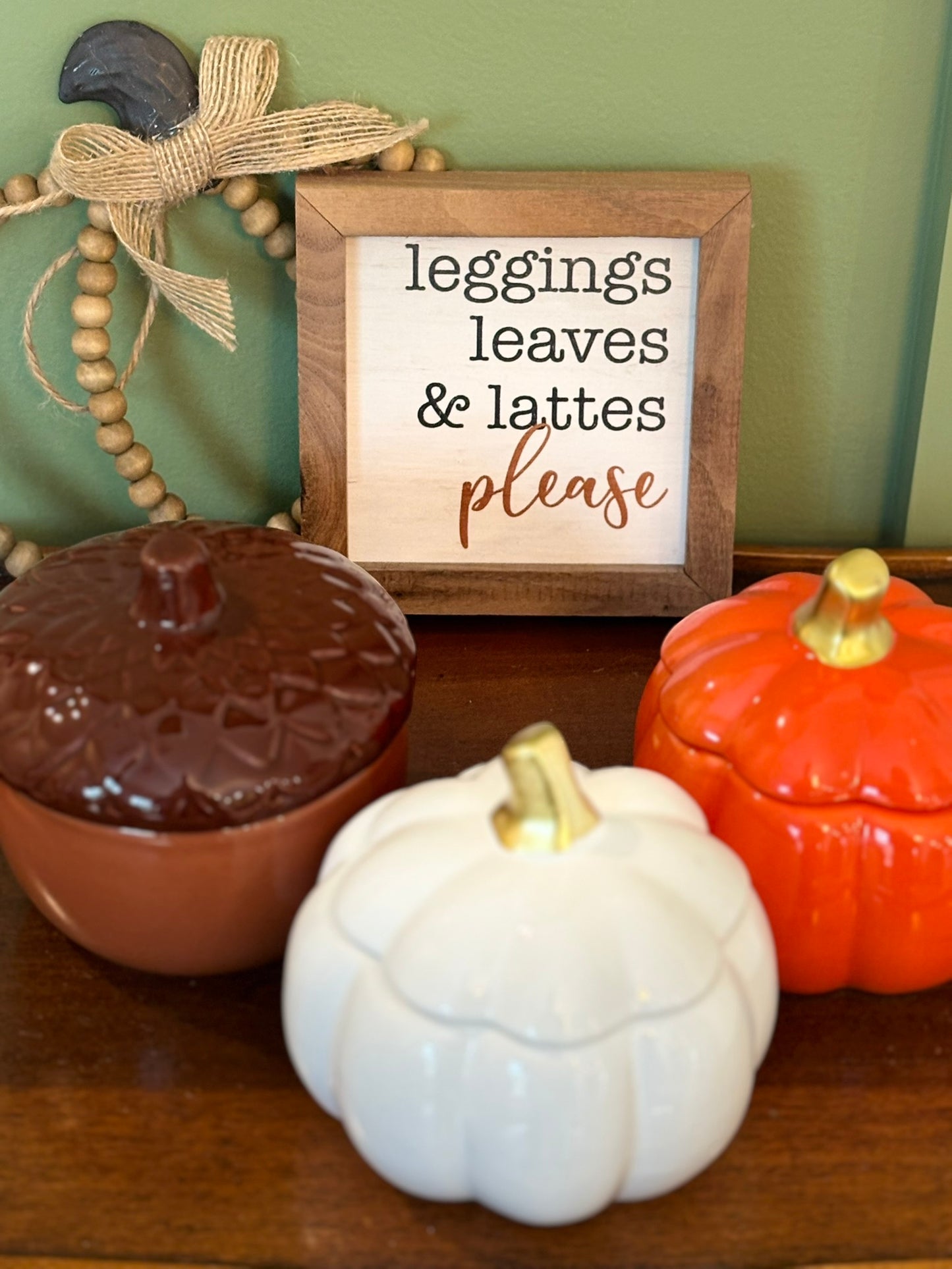 Brown acorn, white pumpkin, and orange pumpkin ceramic vessels with LUMOS fall scented soy candles