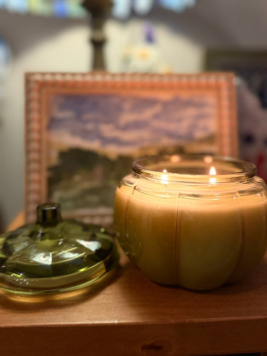 14 oz Green Glass Pumpkin Candle in glossy ribbed glass, with a rounded pumpkin shape and two burning wicks.
