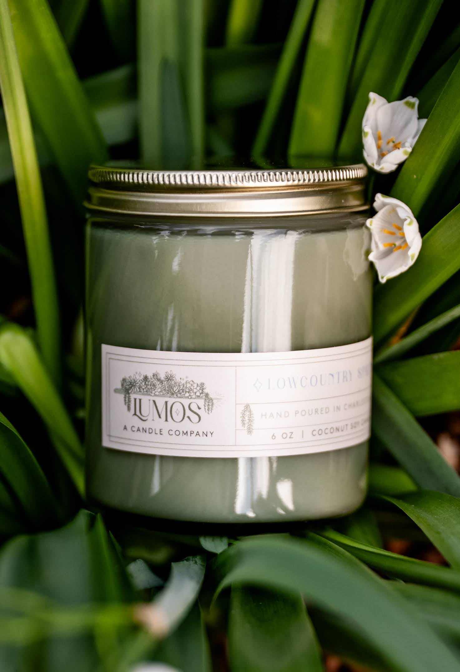 LUMOS Hand-Poured Coconut Soy Candle in sage green glass with golden lid, luxury home fragrance, clean-burning soy wax, 12 oz.