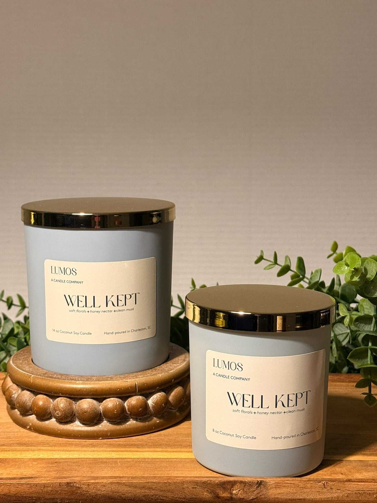 Well Kept double-wick candle in a matte pale blue glass vessel with a gold lid and cream label